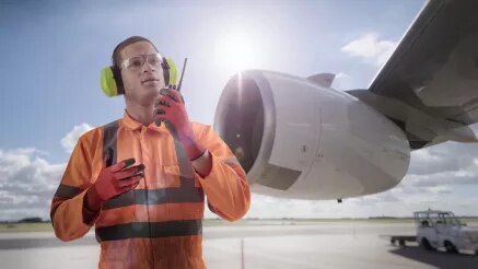 Airport worker with PTT device